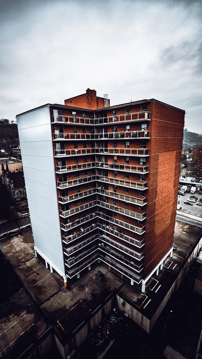 high rise aerial photography of brown-and-white concrete high-rise building urban